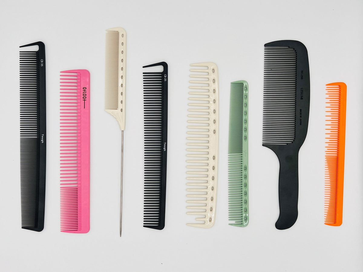 A lineup of professional cutting combs in black, pink, cream, green and orange